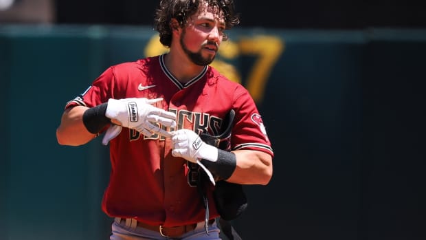 Dominic Fletcher standing on base with his helmet off during a game on May 17th, 2023.